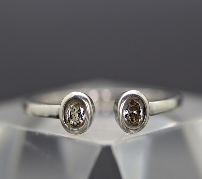 a close up of a ring with a diamond on it