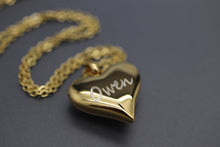 a gold heart shaped necklace with a name on it