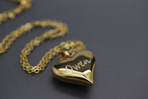 a gold heart necklace with a name on it