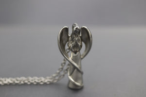 a silver angel figurine on a silver chain