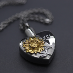 a heart shaped pendant with a sunflower on it