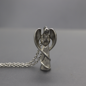 a silver angel pendant on a silver chain