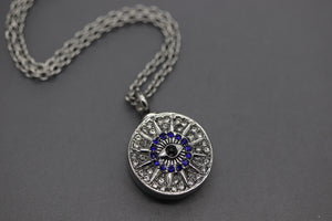 a silver necklace with a blue and white pendant