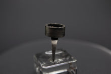 a ring that is sitting on top of a glass block