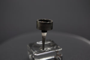 a ring that is sitting on top of a glass block