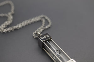 a necklace with the word daddy written on it
