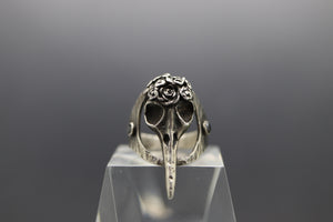 a silver ring with a rose on top of it